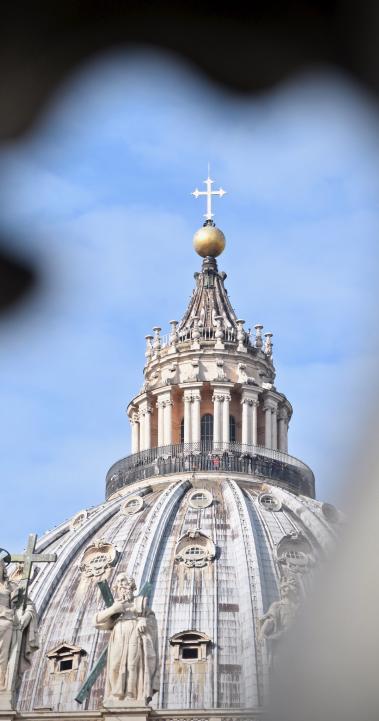 a cross atop a dome at the Vatican